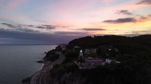 Aerial view of coastal lighthouse on cliffs in Calella, Mediterranean Sea 스톡 동영상 318975700