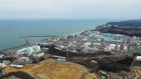 Aerial view of a coastal nuclear power plant facility in Fukushima Stock Footage 346400482