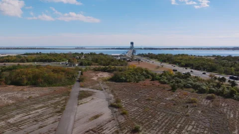 Aerial view of coastal path and distant bridge over water, ProRes 422HQ footage Stock Footage 331273065