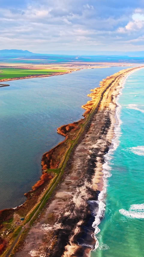 Aerial view of coastal sandbar between lagoon and sea, Bulgaria Vertical video. Stock Footage 338007778