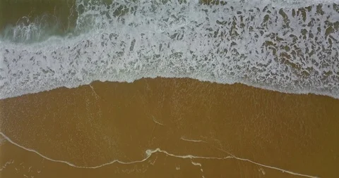 Aerial view of a coastal section with approaching breaking waves and spray Video stock 123406771