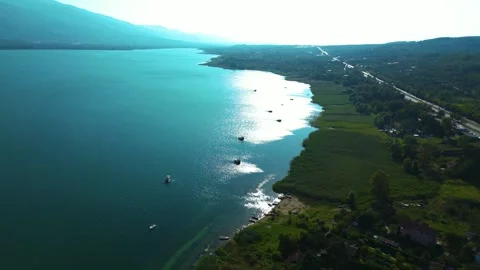 Aerial View of Coastal Town Surrounded by Green Hills Stock Footage 342345895