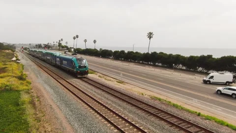 Aerial view of a Coaster train at San Elijo State Beach, Encinitas CA Stock Footage 332541493