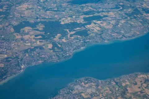 Aerial View of Coastline and Patchwork Countryside Bordering a Deep Blue Lake Stock Photos