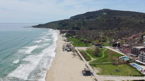 Aerial view of coastline beach waves and resort buildings landscape Stock-Footage 332938690