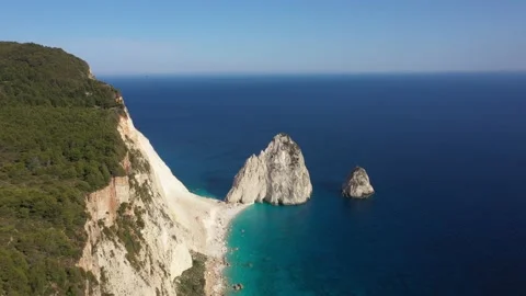 Aerial view of a Coastline with cliffs and blue water on a Greek island Stock Footage 229852186