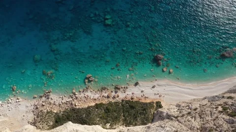 Aerial view of a Coastline with cliffs and blue water on a Greek island Stock Footage 229863969