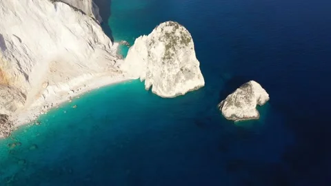 Aerial view of a Coastline with cliffs and blue water on a Greek island Stock Footage 229877037