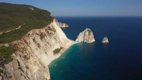 Aerial view of a Coastline with cliffs and blue water on a Greek island Stock Footage 229883044
