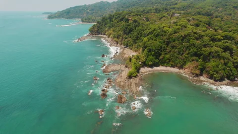 Aerial view of coastline with cliffs and turquoise ocean in sunlight Costa Rica Video stock 342774339