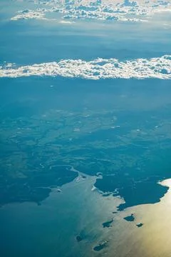 Aerial view of the coastline through the clouds (Australia) Stock Photos