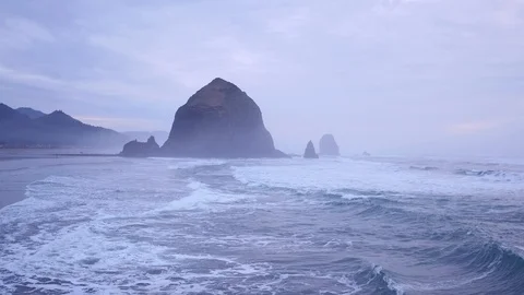 Aerial view of coastline toward Haystack Rock at sunrise on the Oregon Coast Stock Footage 108407877