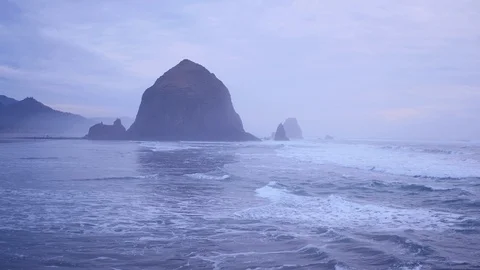 Aerial view of coastline toward Haystack Rock at sunrise on the Oregon Coast 動画素材 108408354