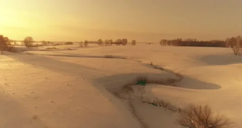 Aerial view of cold arctic field landscape, trees with frost snow, ice river and Stock Footage 165570567