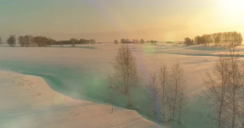 Aerial view of cold arctic field landscape, trees with frost snow, ice river and Stock Footage 165570635