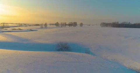 Aerial view of cold arctic field landscape, trees with frost snow, ice river and Stock Footage 165570984