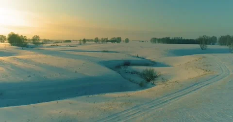 Aerial view of cold arctic field landscape, trees with frost snow, ice river and Stock Footage 291921834