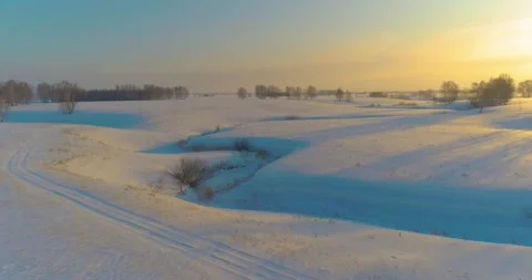 Aerial view of cold arctic field landscape, trees with frost snow, ice river and Stock Footage 307381076