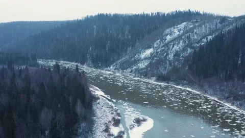 Aerial view of the cold river, rocks and forest in early winter Video stock 146674215