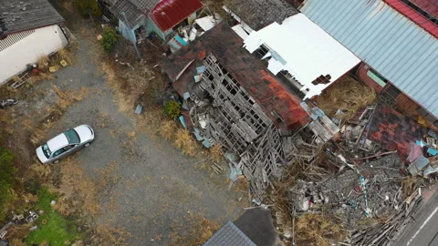 Aerial View of Collapsed Building and Car in Tomioka Stock Footage 346404053