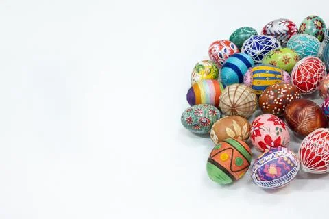 An aerial view of a collection of Easter eggs arranged on the right against a Stock Photos