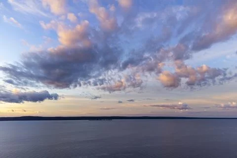 Aerial view of colored sky clouds at sunset time over lake Stock-Fotos