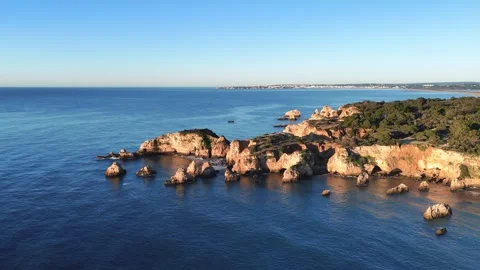 Aerial view of the colorful limestone cliffs and rocks at sunrise, Portugal Stock Footage 266323996