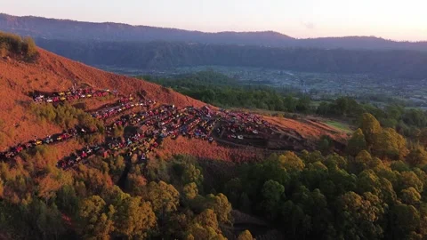 Aerial view of colorful off road safari cars on volcano slope at sunrise Bali Stock Footage 343160661