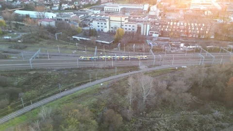 Aerial view of a colorful train navigating through railway tracks Stock Footage 321420498
