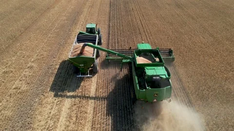 Aerial view of combine harvester unloadi... | Stock Video | Pond5