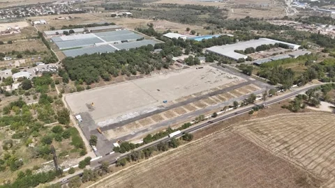 Aerial View of Commercial Land Plot Beside Road and Greenhouse Complex Stock Footage 346162261