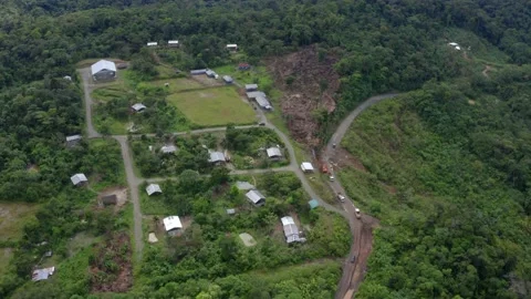 Aerial view of a community inside a forest with construction work trucks Stock Footage 160312023