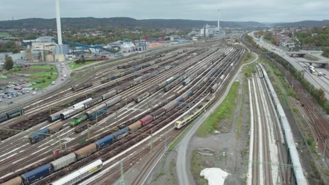 Aerial View of commuter train passing by train depot Savenas, Gothenburg, Sweden 動画素材 344530639