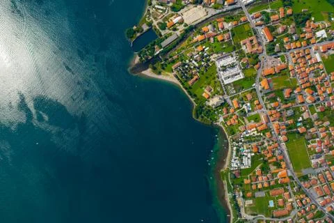 Aerial view of Como lake, Dongo, Italy. Coastline is washed by blue turquoise Stock Photos