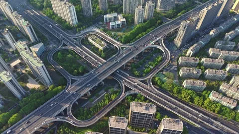Aerial view of a complex highway interchange surrounded by tall buildings and Stock Footage 310116427