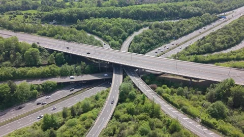 Aerial View of a Complex Highway Junction Surrounded by Green Trees 스톡 동영상 336684089