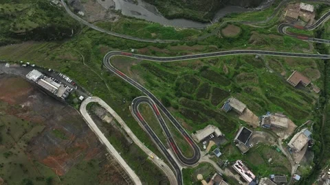 Aerial view of complex winding road network around plateau village in Daocheng Video stock 336698146