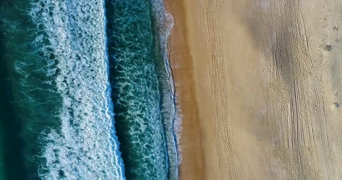 Aerial view of the Comporta Beach with the waves breaking on the shore Stock Footage 130968512