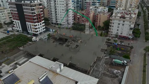 Aerial View: Concrete is poured efficiently as workers and engineers ensure Stock Footage 296074352
