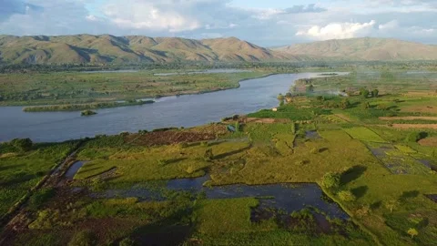 Aerial view of the congo river flowing through lush green vegetation and distant Stock Footage 316950539