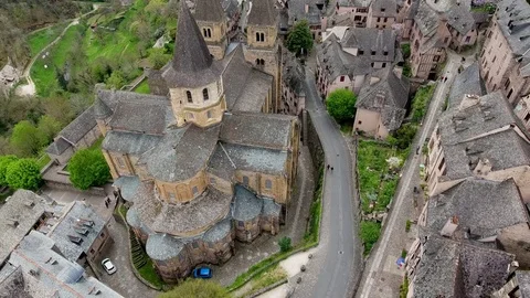 Aerial view. Conques town: old houses &amp; ancient abbey church of St. Foy, France Vídeos de archivo 75876590