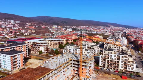 Aerial view of construction crane above hillside town, Bulgaria Video stock 339000704