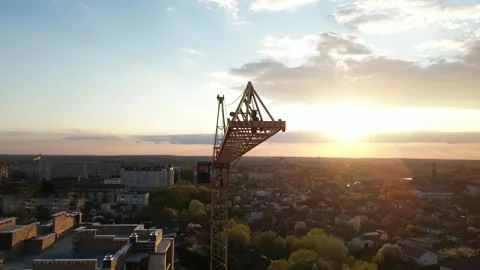 Aerial view of construction crane jib over city at sunset Video stock 335406084