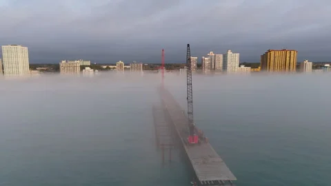 Aerial View of Construction Cranes Rising Through Morning Fog in Myrtle Beach Stockbeeldmateriaal 339220127
