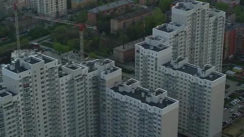 An aerial view of the construction of a house next to the built houses. Stock Footage 134428362