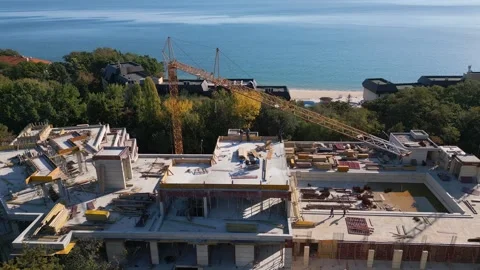 Aerial view of the construction of a massive beachfront hotel Stock Footage 255371452