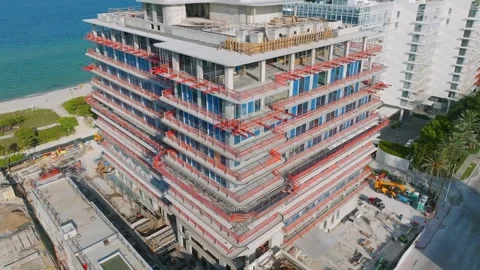 Aerial view of construction of multi-storey buildings near seashore with Stock Footage 245955451