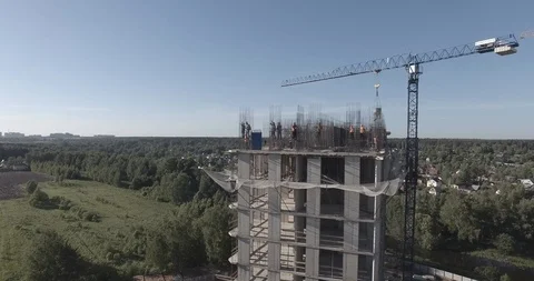 Aerial view on construction of multistory apartment building with workers Stock Footage 105080244
