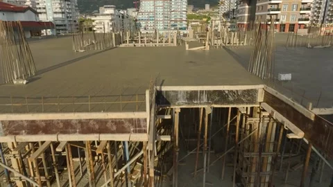 Aerial View: The construction site is alive with activity as workers and Stock Footage 296076105