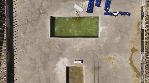 Aerial View: A construction site alive with workers insulating foundations and Video stock 296095096